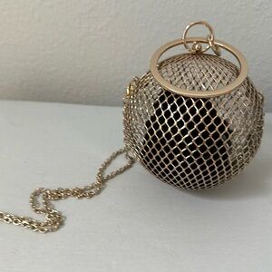Gold metal bag in a shape of a ball
